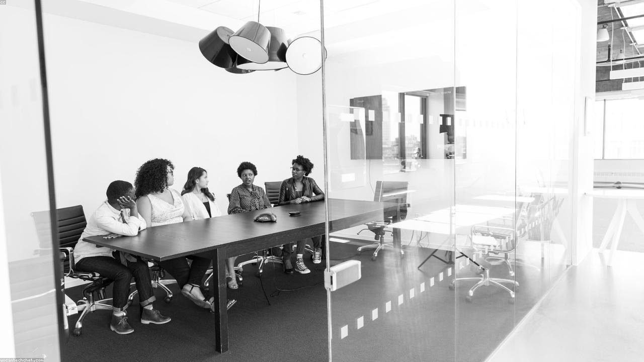 Small business team reviewing customer workflow and lead assignments together at a computer.