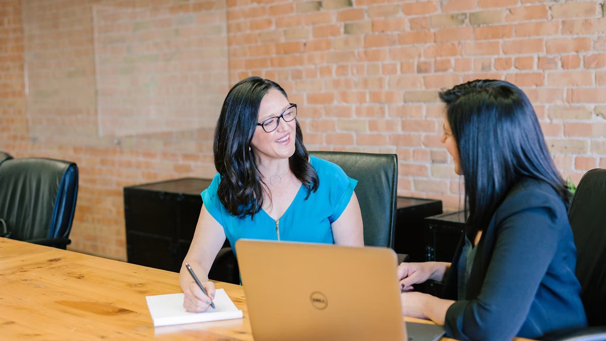 Consultant and client discussing a service proposal and package options at a desk.