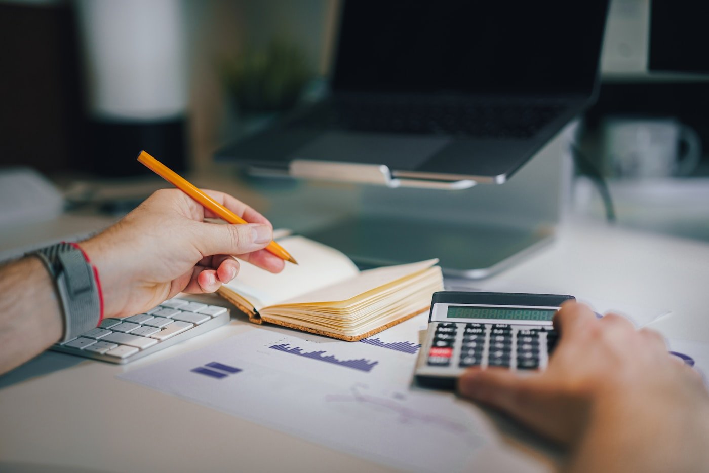 Small business owner reviewing pricing, cash flow, and upcoming work at a desk.